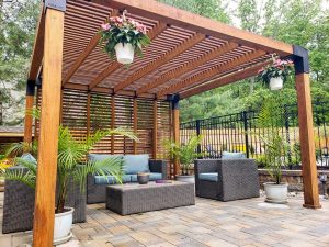 Residential landscaping. Furnished patio with pergola for shade