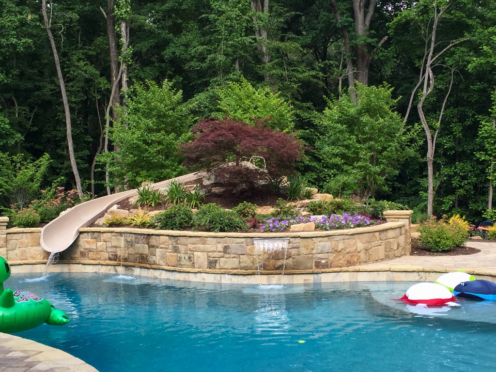Pool patio with raised bed and slide