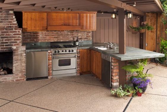 Residential landscaping. Design and build outdoor kitchen with appliances and fireplace