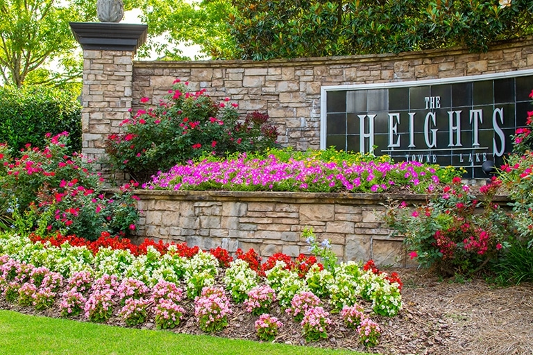 The Heights at Town Lake residential community sign maintained by Oasis Landscapes