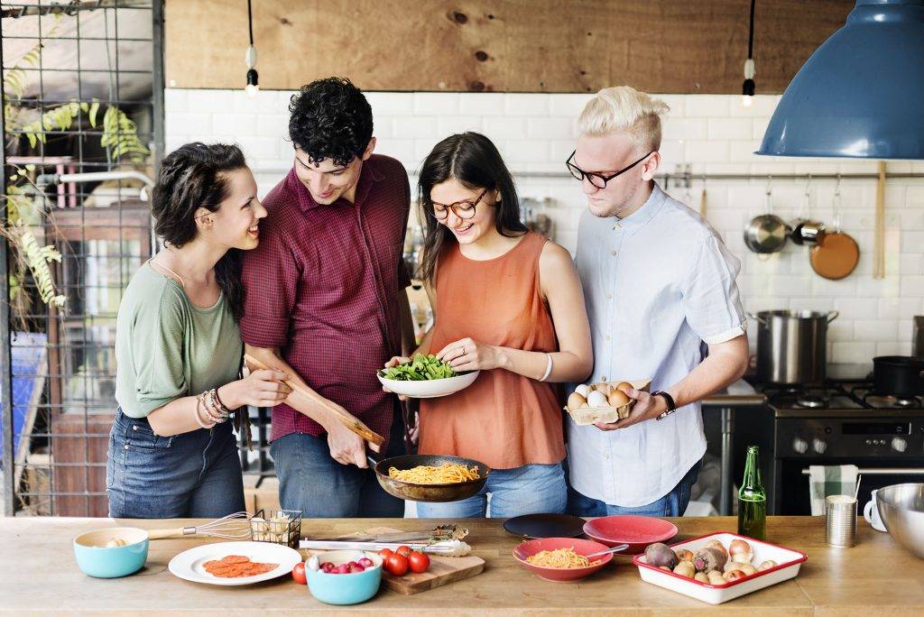 Friends dining outdoors by an outdoor kitchen