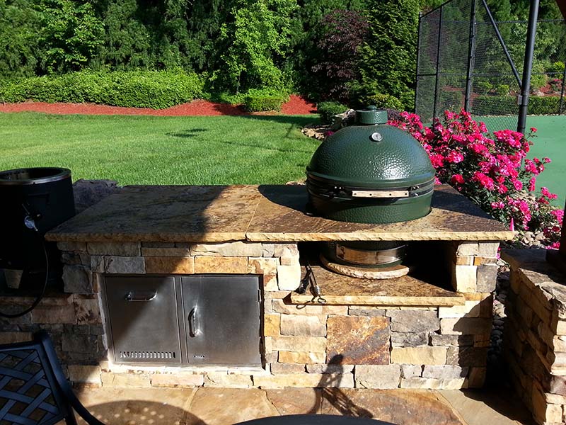 https://oasislandscape.com/wp-content/uploads/2023/06/outdoor-kitchen-grill-with-green-top.jpg
