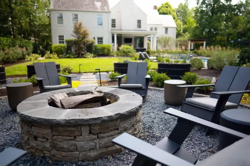 a cozy firepit surrounded by lush green grass and landscaping