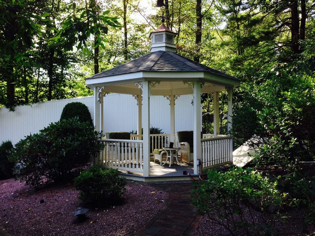 White gazebo in shaded backyard