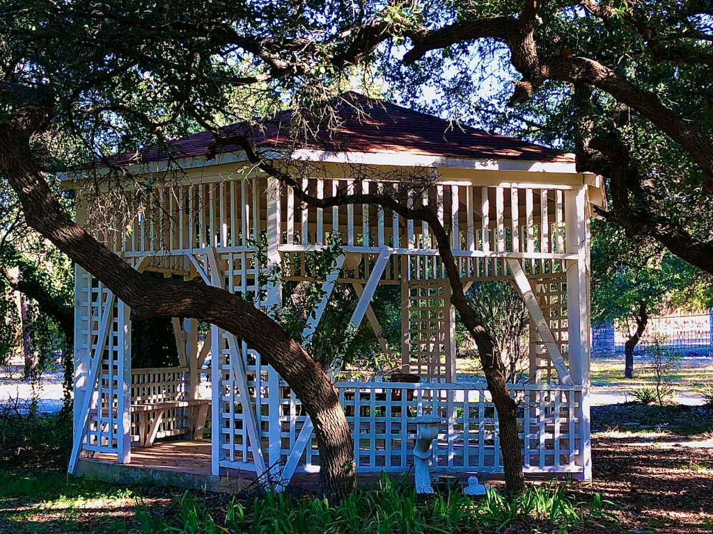 Open gazebo in rustic setting under trees