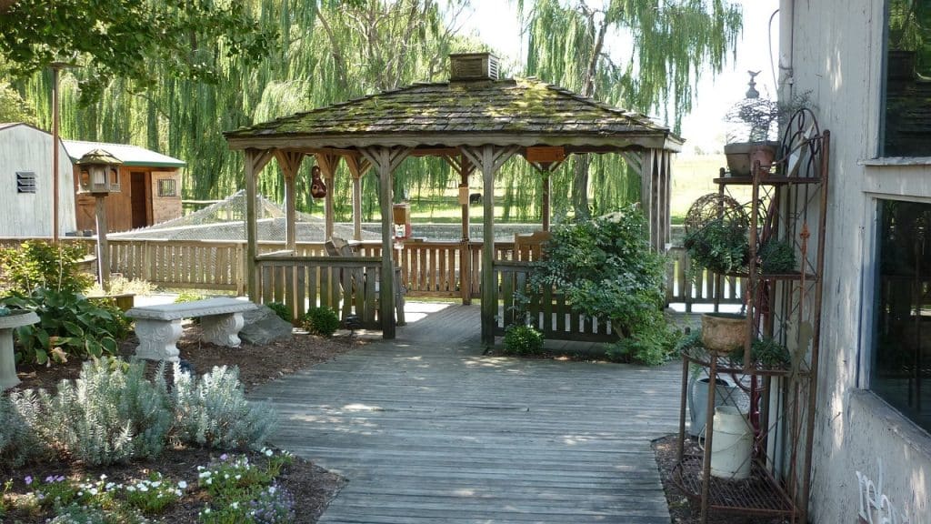 Wooden gazebo on patio with garden view