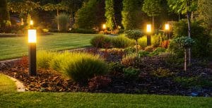 Illuminated garden path with glowing bollard lights.